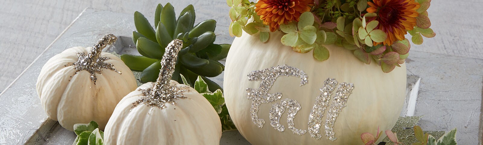 Silver glitter on white pumpkins